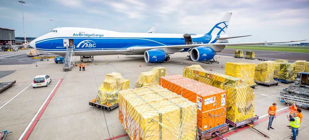 Avión en un hub logístico multimodal en México con contenedores de carga